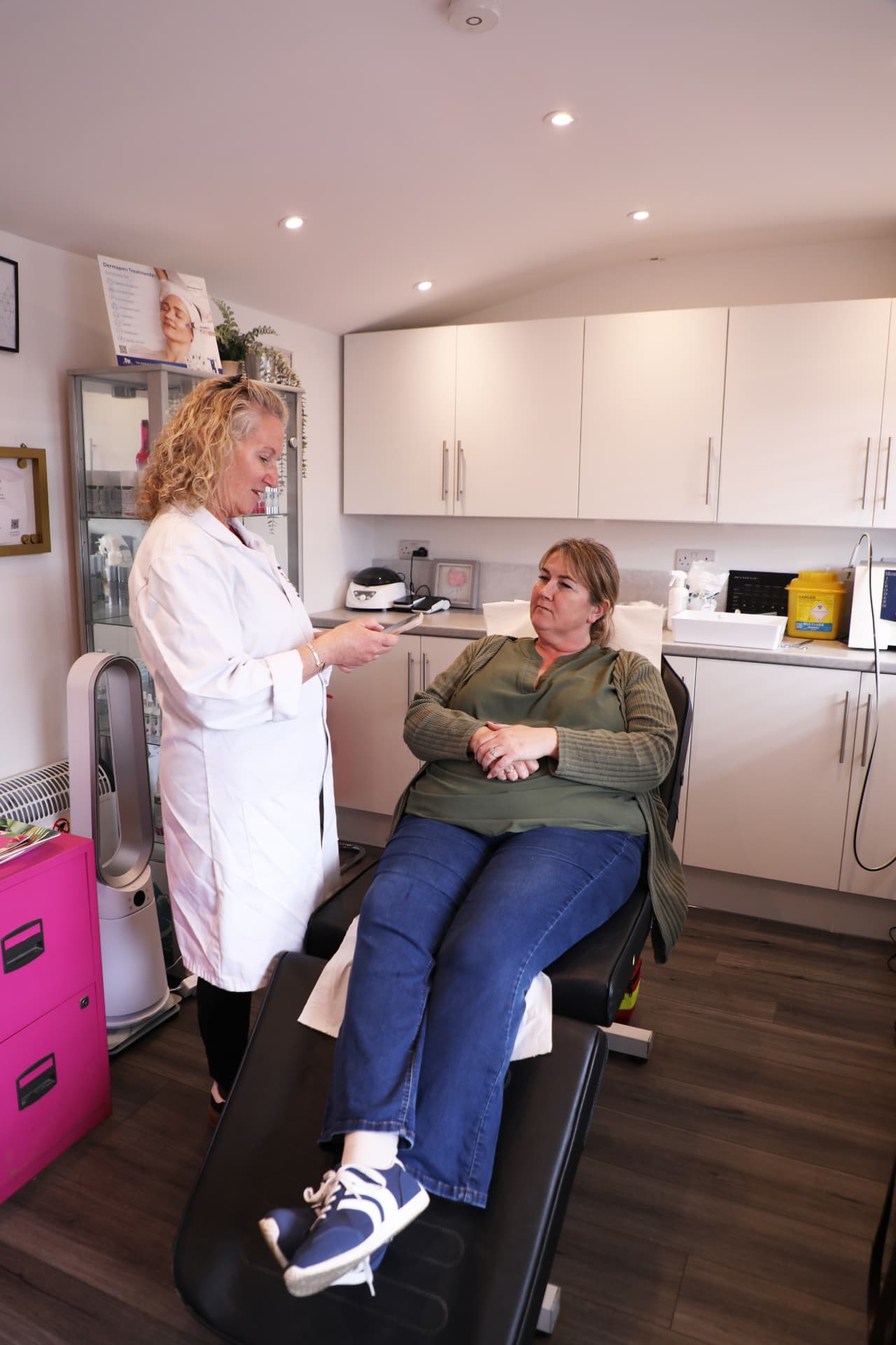 Calm treatment room at The Flamingo Clinic with soft pink furnishings and skincare serums